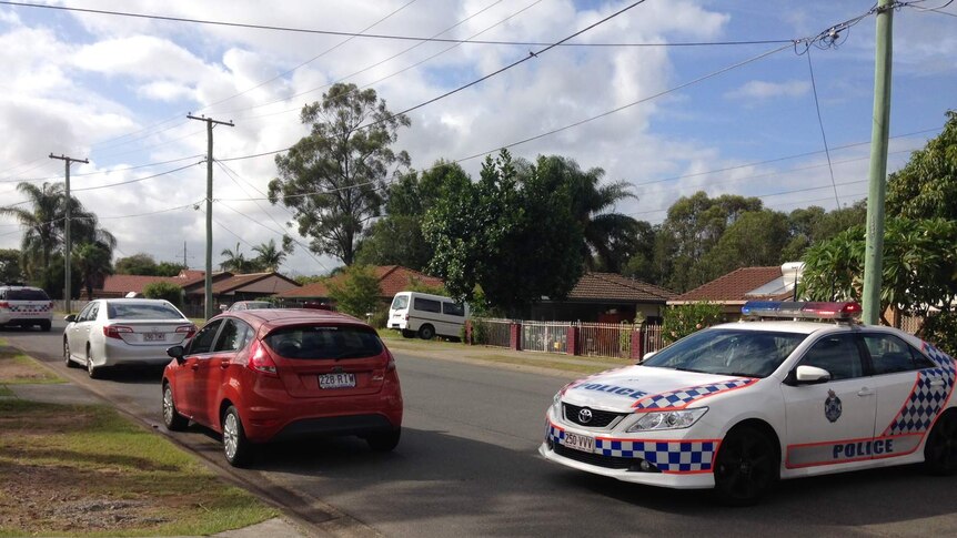 Police at the Kingston Street house, after the man was taken into custody.