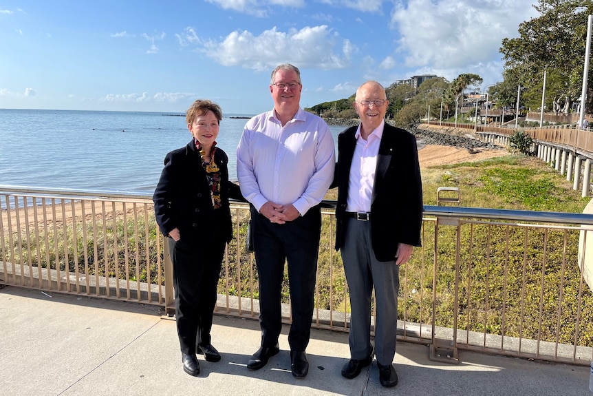 Three elderly people on a jetty 