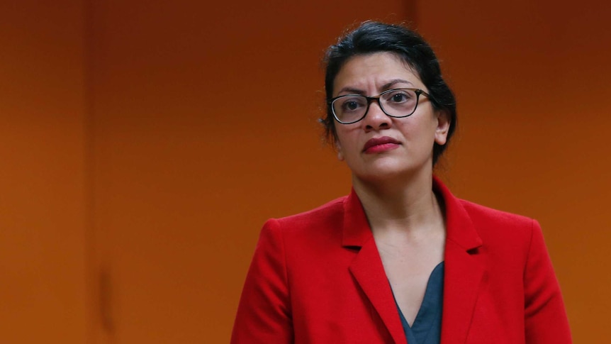 US Congresswoman Rashida Tlaib wearing a red jacket.