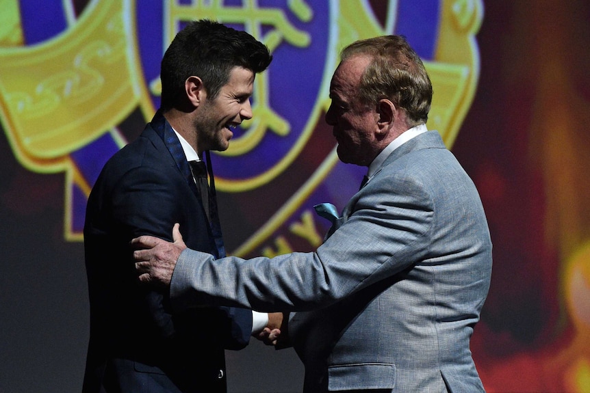 Trent Cotchin (left) is retrospectively awarded the 2012 Brownlow Medal by 1971 medallist Ian Stewart.
