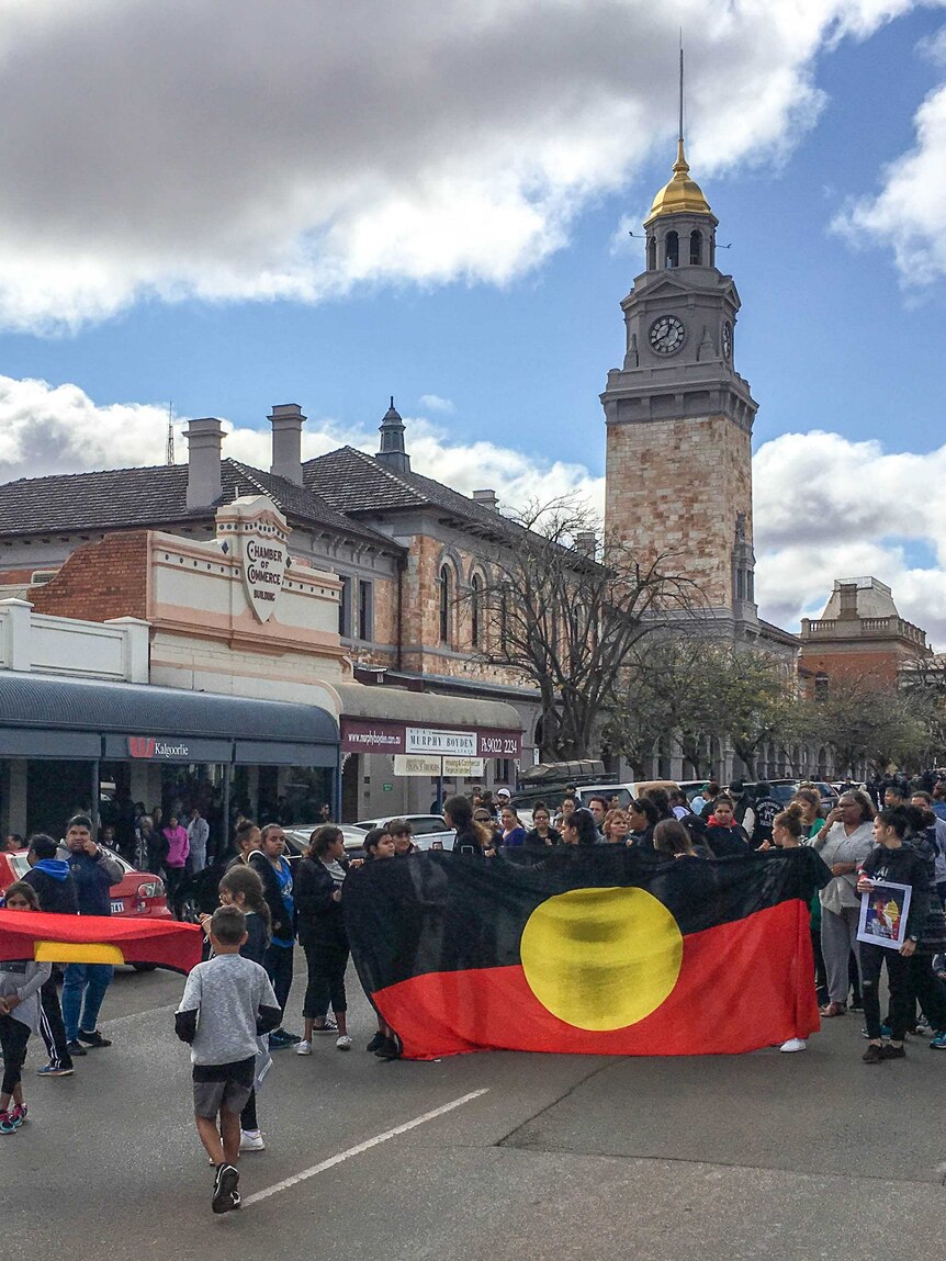 Image of a group of people marching down Hannan Street in Kalgoorlie, Western Australia.