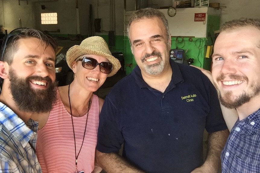 Fulton, Daniel, Whalan and mechanic smiling to camera in garage.
