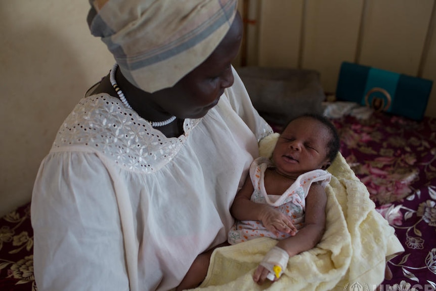 A woman sits with her newborn baby in the Maban hospital's maternity ward.