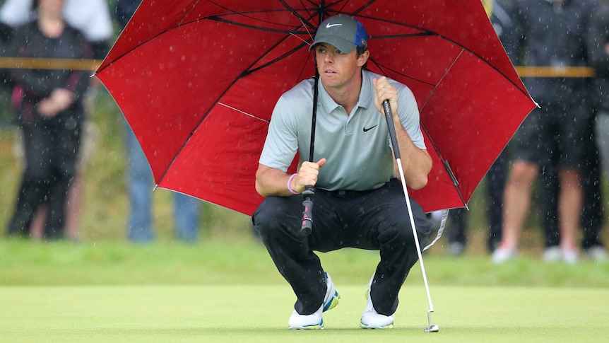 McIlroy eyes up a putt in the rain at Royal Liverpool