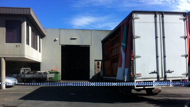 Police attend the scene in Campbellfield where a man died underneath a vertical box stacker.