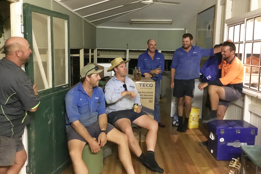 Group of volunteers enjoy a beer in a sleep out.