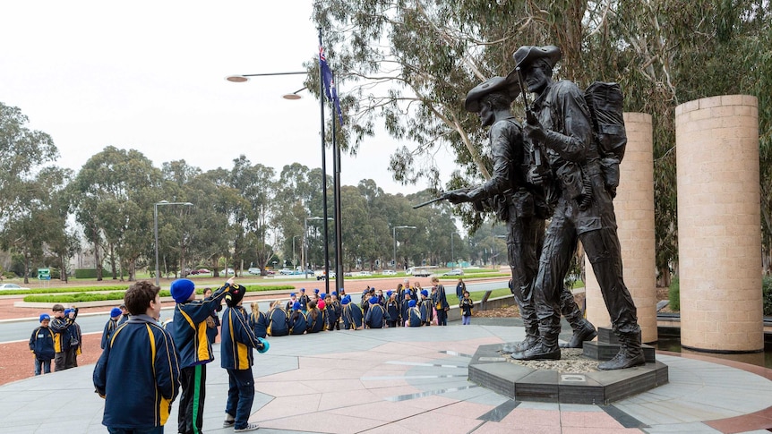 Young students taking photos of memorials at Anzac Parade