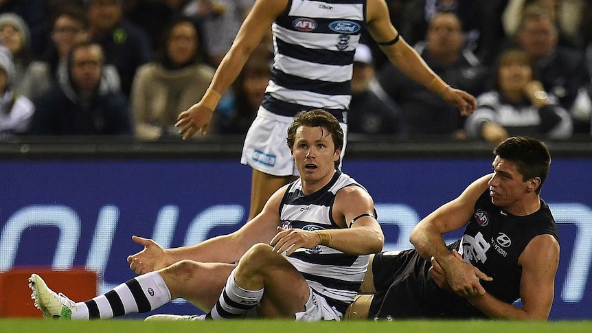 Mathew Kreuzer was groggy after a heavy tackle from Patrick Dangerfield. (Photo: AAP)