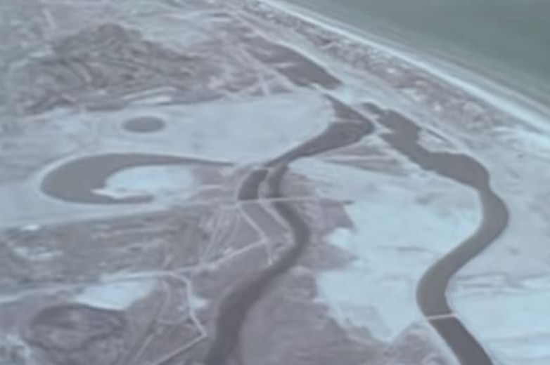 A black and white image of rivers leading to the ocean