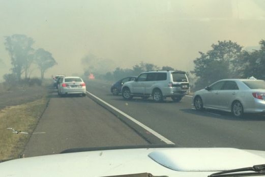 Smoke on road and traffic congestion from grassfire north of Marulan