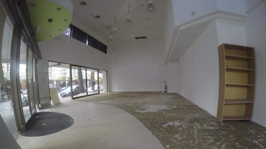 An empty shop in Surfers Paradise displays a for lease sign