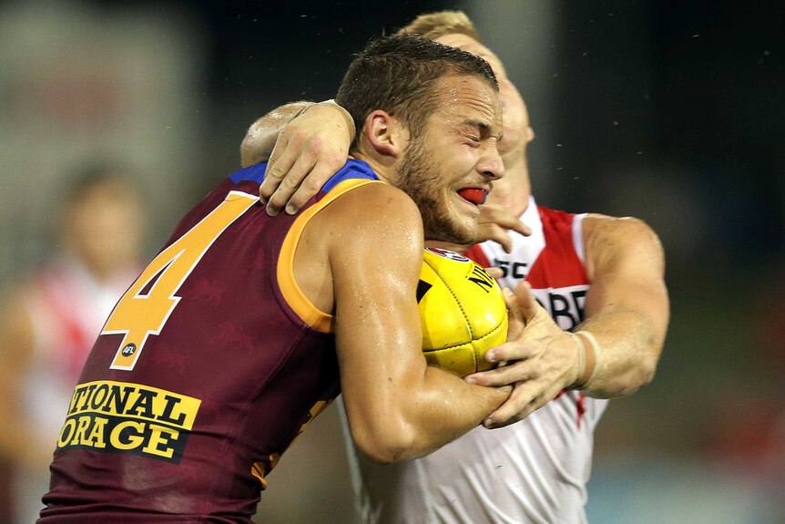James Aish of the Brisbane Lions is tackled