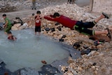 Boy jumps into water-filled crater