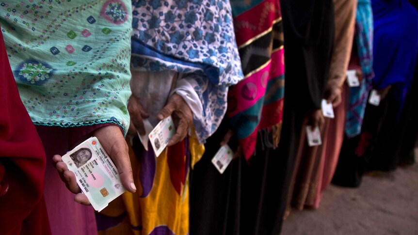 Bangladeshi women line up outside a polling station to cast their votes in Dhaka, Bangladesh.