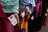 Bangladeshi women line up outside a polling station to cast their votes in Dhaka, Bangladesh.
