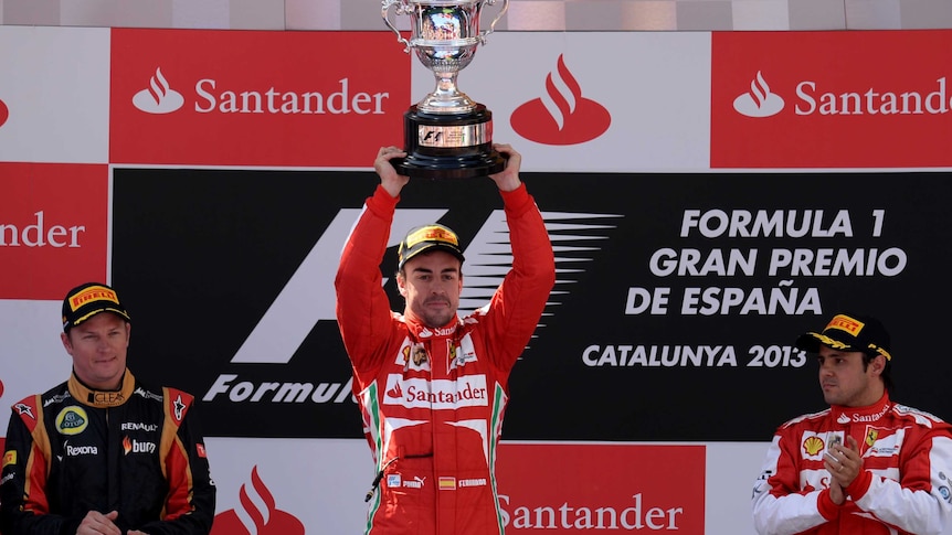 Fernando Alonso lifts the trophy after winning the Spanish Grand Prix