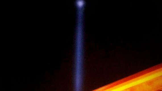 Spectra light tower disappears into the night sky.