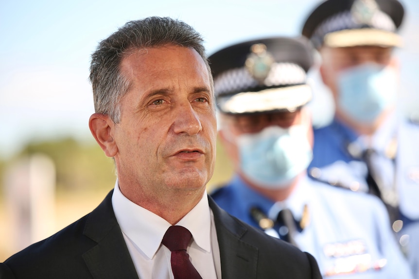 A head and shoulders shot of WA Police Minister Paul Papalia speaking at a media conference outdoors.