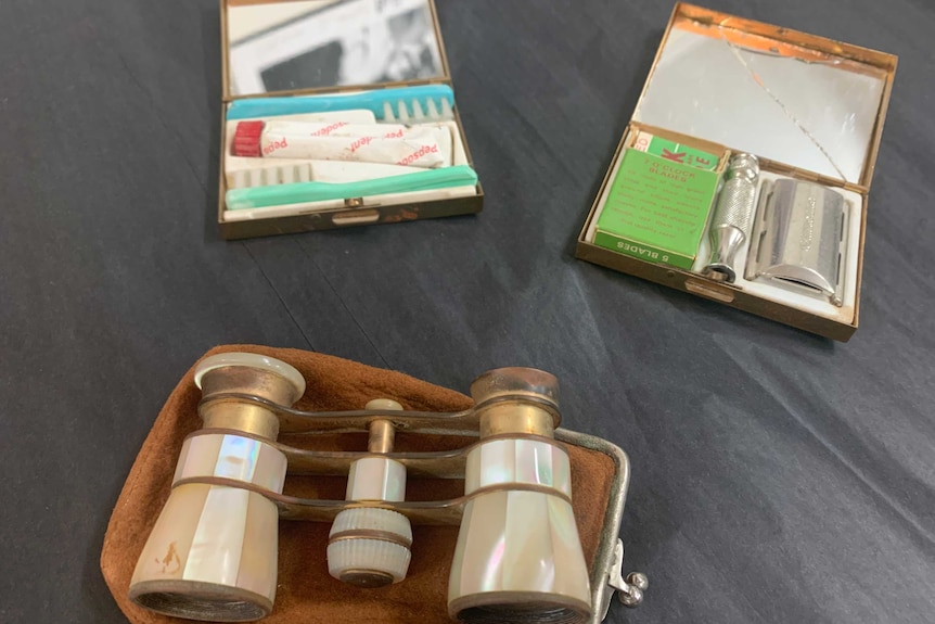 Travelling gold cases for toothbrush, razor and antique pearl shell opera glasses