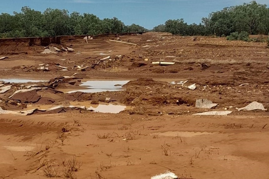 A muddy and eroded stretch of open space that once was the national highway