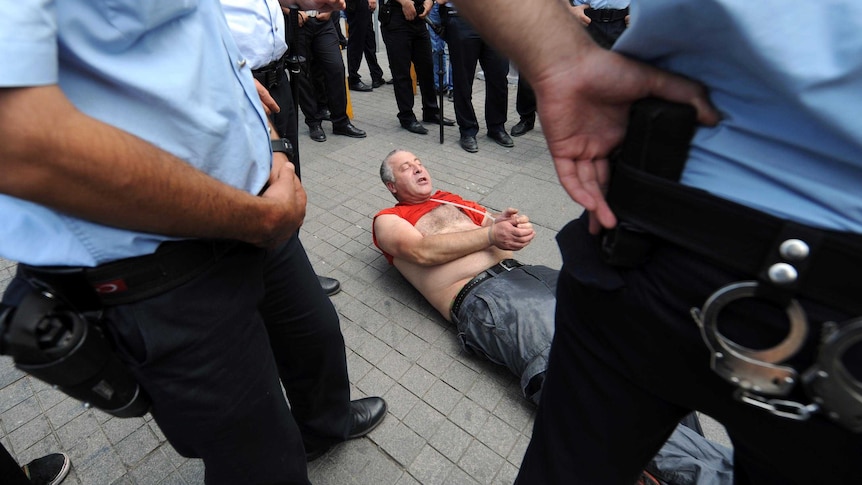 Protester arrested by Turkish police.