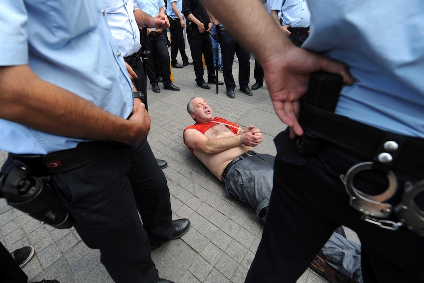 Protester arrested by Turkish police.