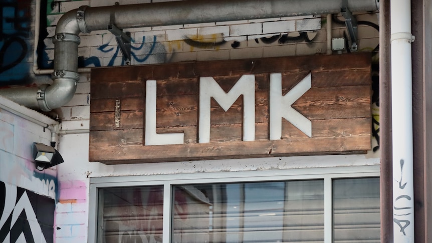 A sign saying 'LMK' above the front door of restaurant Little Miss Korea in the Darwin CBD.