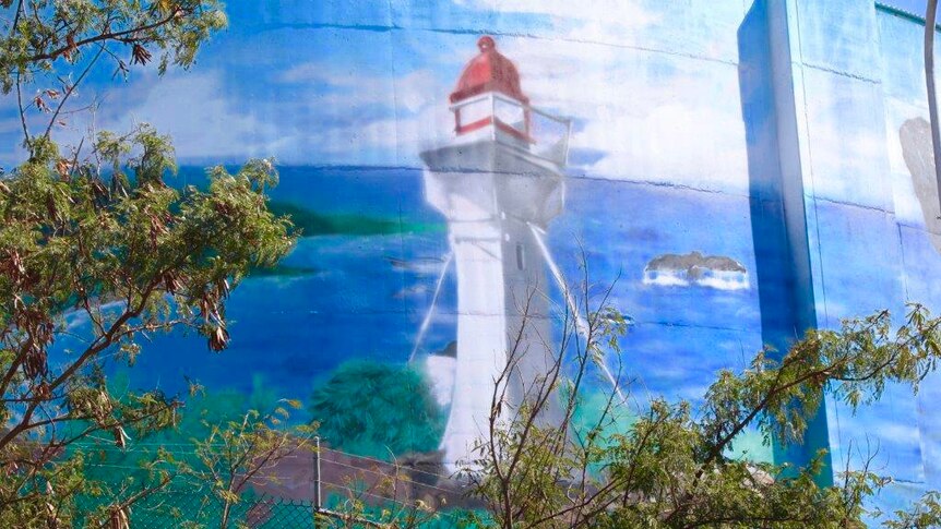 A painting of a lighthouse on a water tower