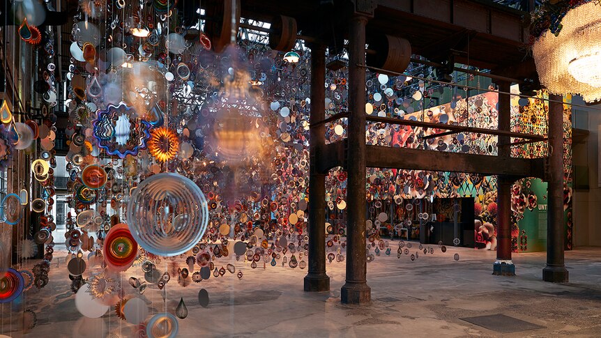 Colour photo of Carriageworks foyer filled with artwork Kinetic Spinner Forest.