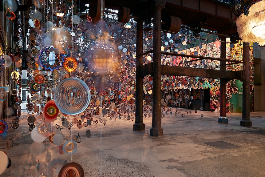 Colour photo of Carriageworks foyer filled with artwork Kinetic Spinner Forest.