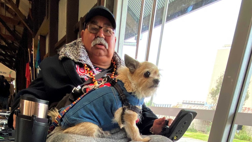 Amputee and Limbs 4 Life volunteer Richard McCarthy in his wheelchair with his dog Ringo in his lap