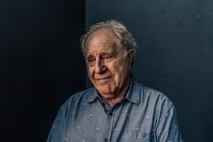 A painting of an elderly man with a black backdrop.