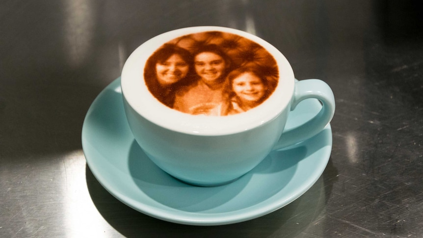 A coffee with a picture printed onto the foam