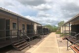 A path flanked by cabins with verandahs at the Howard Springs facility