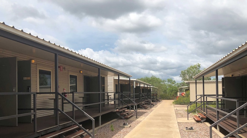 A path flanked by cabins with verandahs at the Howard Springs facility