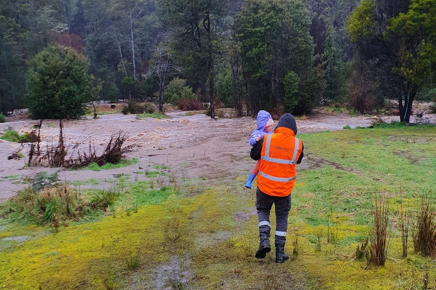 People in wet conditions in a paddock.