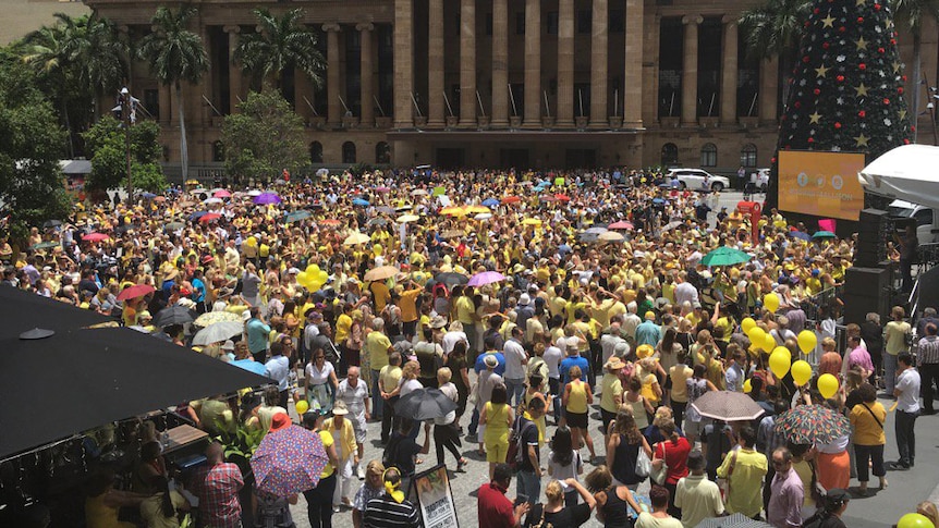 Crowd dressed in yellow gather at King George Square in Brisbane's CBD at rally to support Allison Baden-Clay
