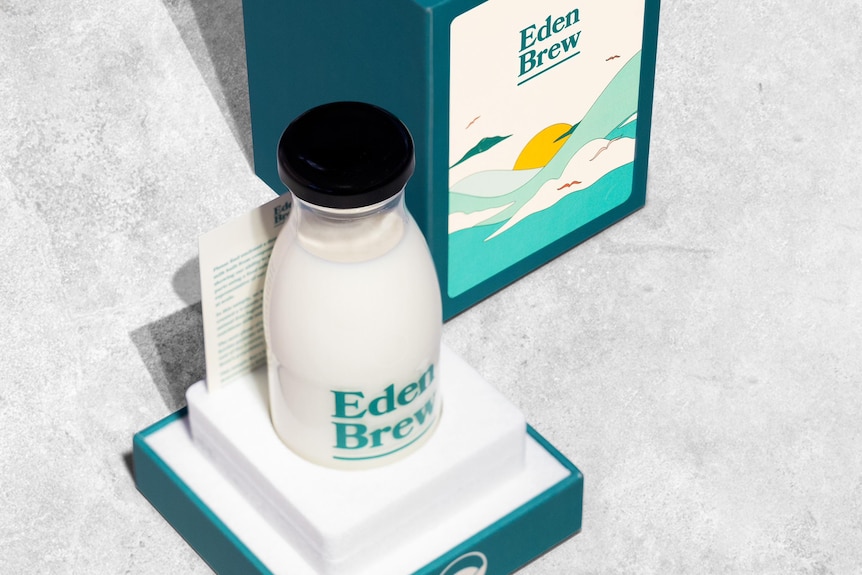 A trophy-like display of a bottle of milk with Eden Brew written on its label