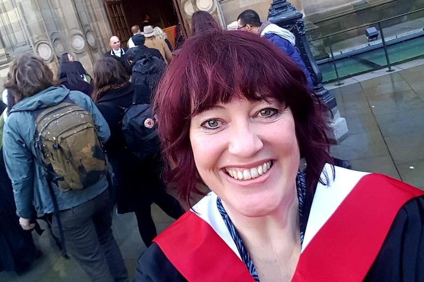 Alison Bunting taking a photo outside Edinburgh University