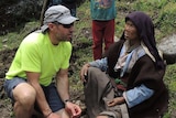 Adrian Hayes assists a Nepalese woman