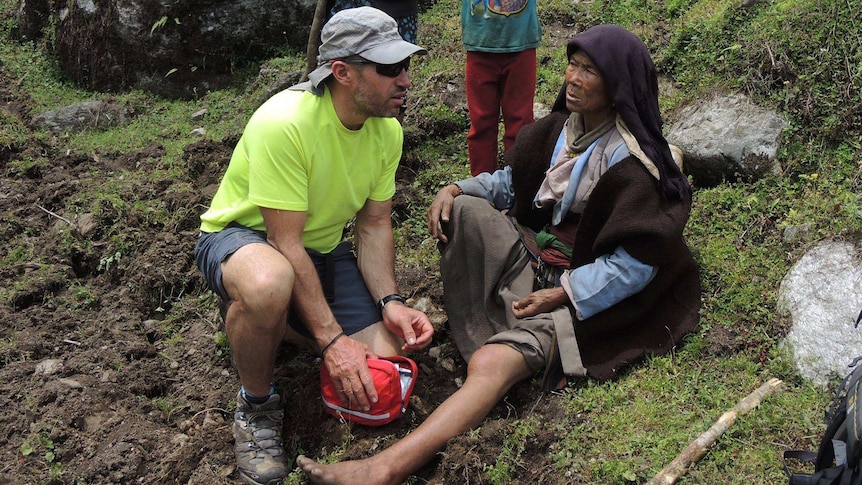Adrian Hayes assists a Nepalese woman