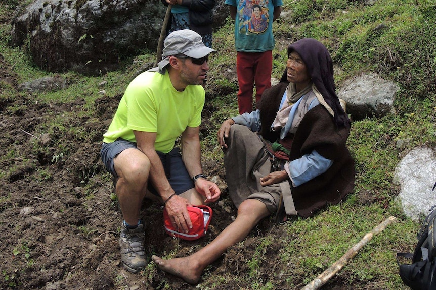 Adrian Hayes assists a Nepalese woman