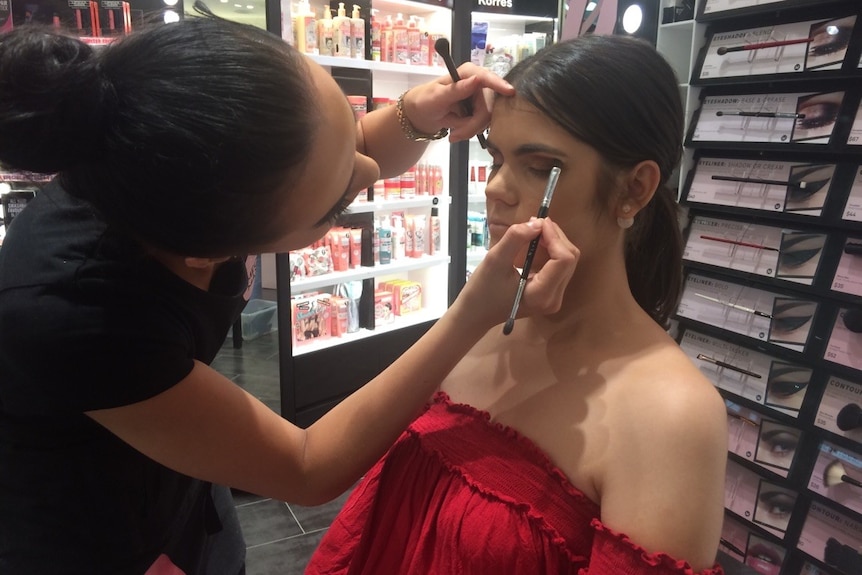 Makeup artist applies makeup to model