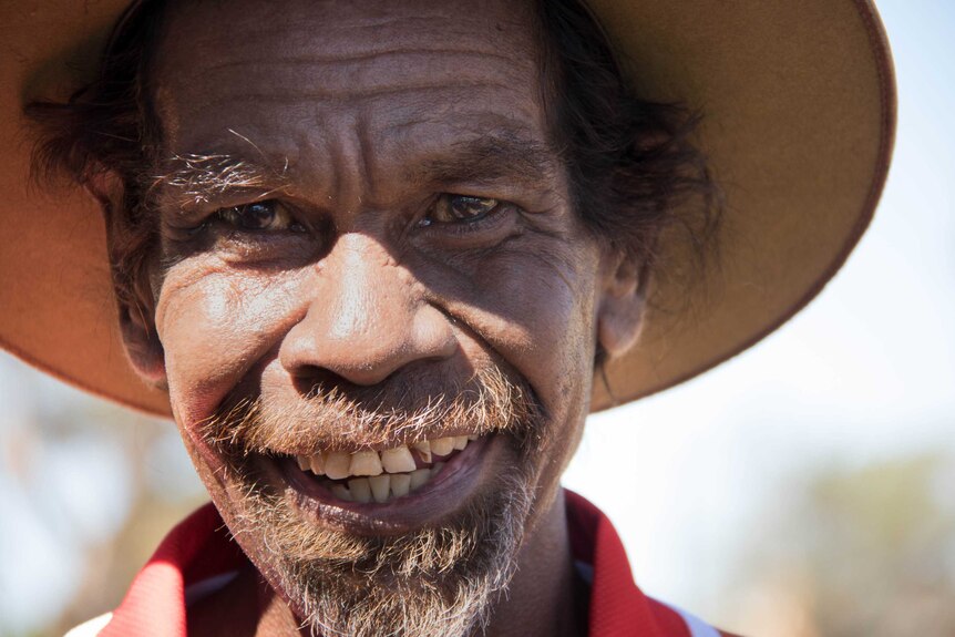 Broome cricketer Pius Gregory looks into the camera with a big smile.