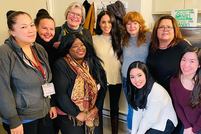 Meghan Markle surrounded by women.