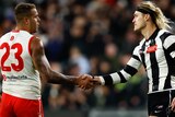 Lance Franklin shakes Darcy Moore's hand after a game