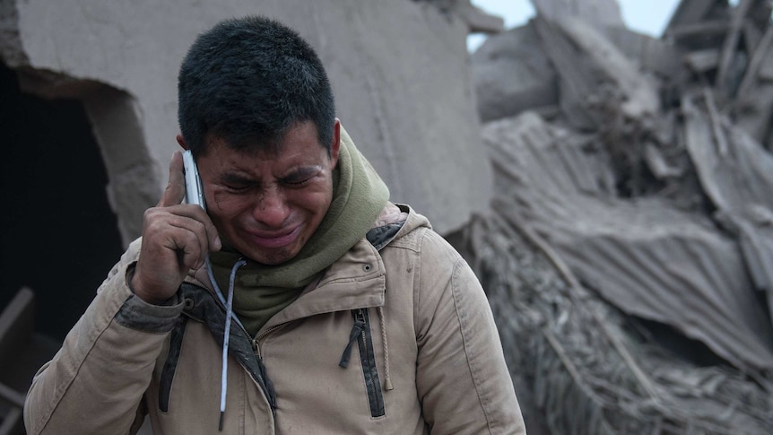 Boris Rodriguez, 24, who is searching for his wife, cries after seeing the condition of his neighbourhood