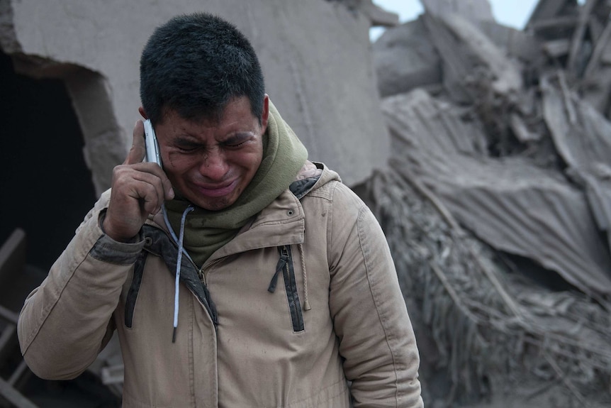 Boris Rodriguez, 24, who is searching for his wife, cries after seeing the condition of his neighbourhood