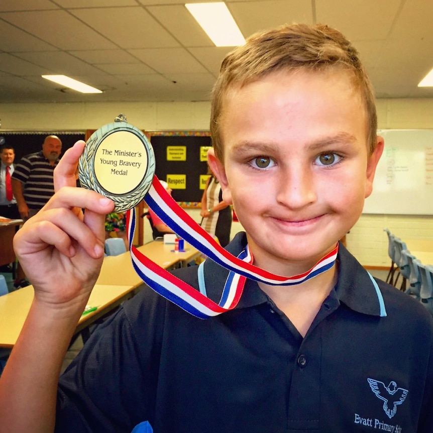 Aaron Zorzi poses with his bravery medal