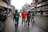 Nepalese police personnel detain a protester during a an anti-charter strike